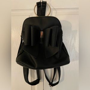 Black backpack purse with bow on front